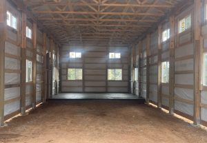 Inside a building with a dirt floor and windows